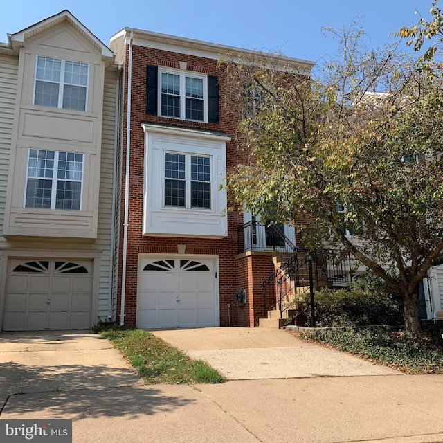 44035 Kings Arms Sq, Ashburn, VA 20147 - multi unit property featuring a garage, driveway, and brick siding