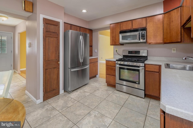 22 Clemson Rd, Cherry Hill, NJ 08034 - kitchen featuring appliances with stainless steel finishes, light countertops, brown cabinetry, recessed lighting, and light tile patterned floors