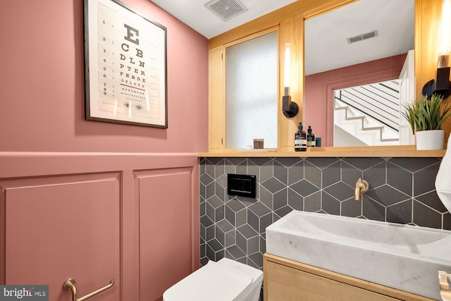2431 Ontario Rd NW Unit 4, Washington, DC 20009 - half bathroom featuring vanity and wainscoting