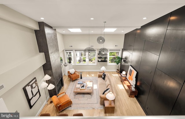 2431 Ontario Rd NW Unit 4, Washington, DC 20009 - living room with light wood-style flooring, recessed lighting, a fireplace, and a towering ceiling