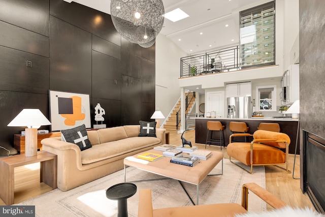 2431 Ontario Rd NW Unit 4, Washington, DC 20009 - living room featuring a high ceiling, light wood finished floors, stairs, and recessed lighting