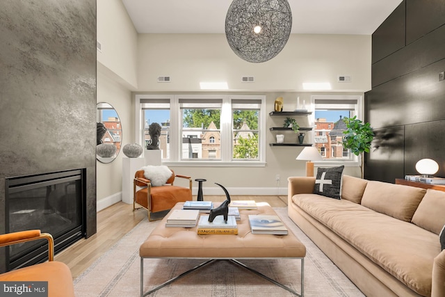 2431 Ontario Rd NW Unit 4, Washington, DC 20009 - living area with light wood-type flooring, a fireplace, and a high ceiling