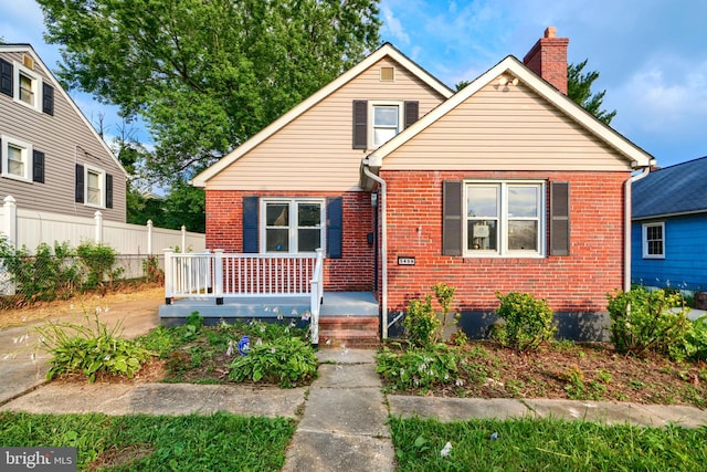 5409 Hillburn Ave, Baltimore, MD 21214 - bungalow-style home with brick siding, a chimney, and a porch