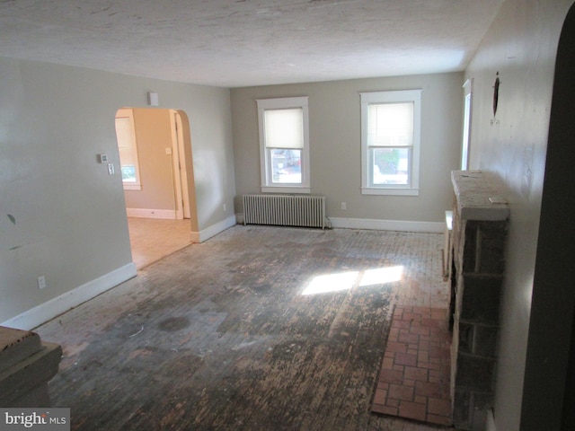 410 Hanover Rd, York, PA 17408 - unfurnished living room with radiator heating unit and arched walkways