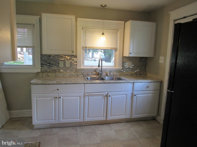 410 Hanover Rd, York, PA 17408 - kitchen featuring freestanding refrigerator, white cabinetry, decorative backsplash, light countertops, and hanging light fixtures