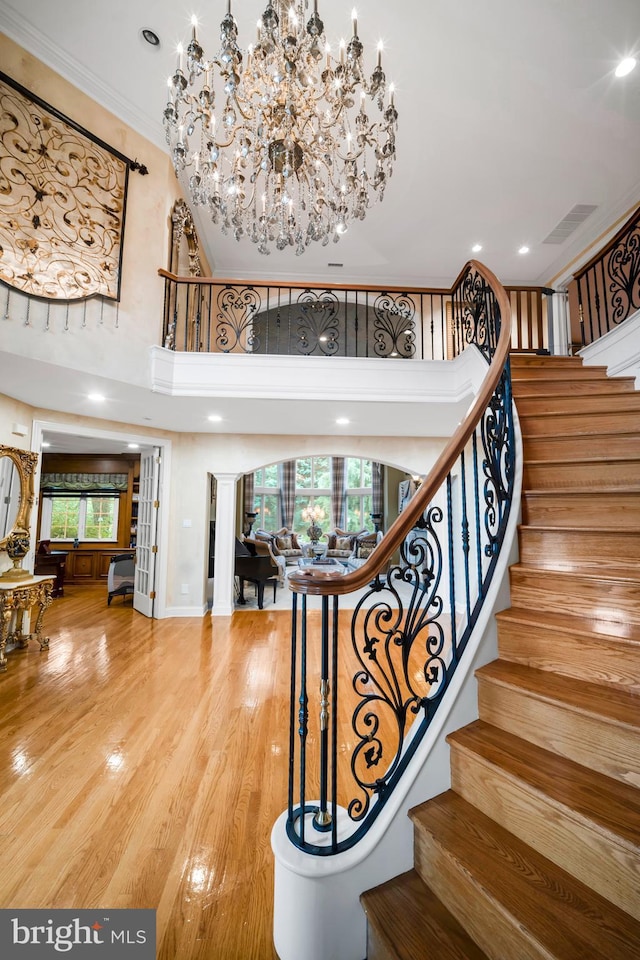 1126 Timbergate Dr, Jenkintown, PA 19046 - staircase with wood finished floors, a high ceiling, decorative columns, ornamental molding, and a chandelier