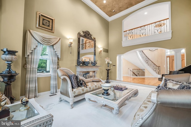 1126 Timbergate Dr, Jenkintown, PA 19046 - living room featuring decorative columns, ornamental molding, a high ceiling, stairway, and arched walkways