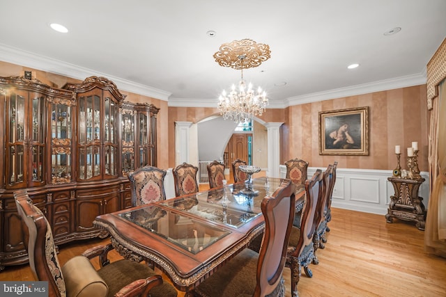 1126 Timbergate Dr, Jenkintown, PA 19046 - dining space with decorative columns, arched walkways, a chandelier, light wood-type flooring, and wainscoting