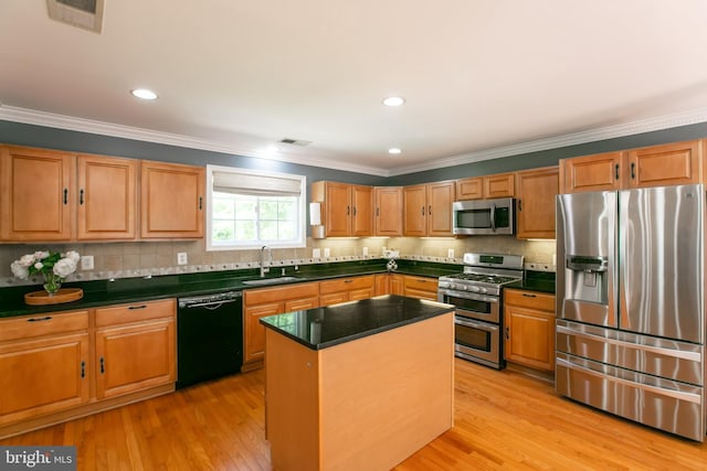 5722 Larpin Ln, Alexandria, VA 22310 - kitchen featuring stainless steel appliances, dark countertops, ornamental molding, tasteful backsplash, and light wood-style floors