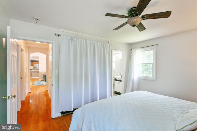 5722 Larpin Ln, Alexandria, VA 22310 - bedroom with arched walkways, wood finished floors, ceiling fan, and ensuite bath