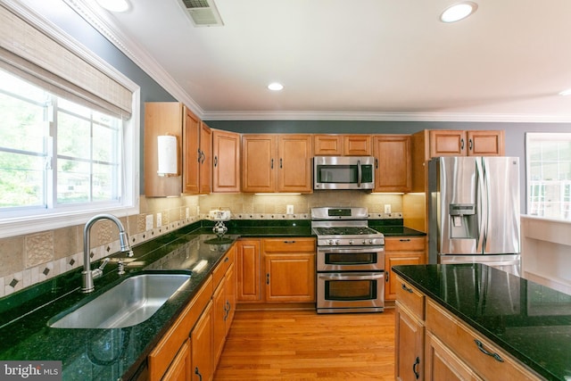 5722 Larpin Ln, Alexandria, VA 22310 - kitchen with appliances with stainless steel finishes, healthy amount of natural light, ornamental molding, dark stone countertops, and recessed lighting