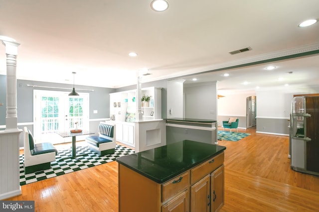 5722 Larpin Ln, Alexandria, VA 22310 - kitchen with stainless steel fridge, light wood-style flooring, recessed lighting, dark countertops, and a center island