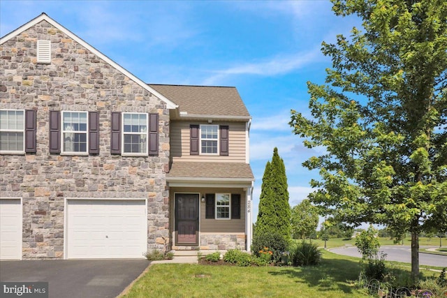 284 S Village Cir, Palmyra, PA 17078 - view of front of property with stone siding, a garage, asphalt driveway, a front lawn, and roof with shingles