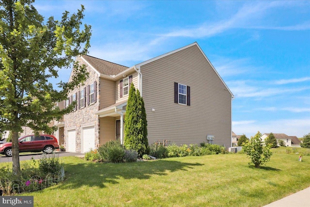 284 S Village Cir, Palmyra, PA 17078 - view of property exterior with an attached garage, stone siding, driveway, and a lawn