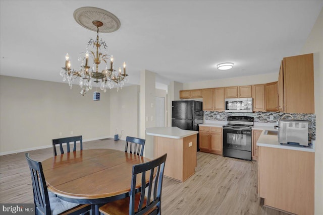 284 S Village Cir, Palmyra, PA 17078 - kitchen with black appliances, light countertops, backsplash, and light wood-style floors