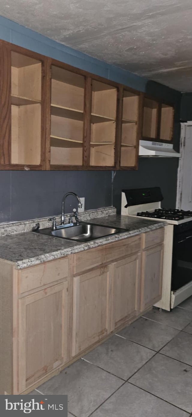 67 Vine St, Trenton, NJ 08638 - kitchen with gas range, under cabinet range hood, light brown cabinetry, and light tile patterned floors