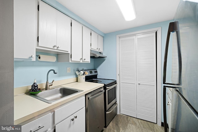 825 N 29th St Unit 5G, Philadelphia, PA 19130 - kitchen with appliances with stainless steel finishes, under cabinet range hood, light countertops, and white cabinetry