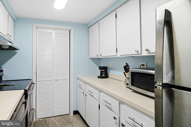 825 N 29th St Unit 5G, Philadelphia, PA 19130 - kitchen with stainless steel appliances, light wood finished floors, white cabinets, and light countertops