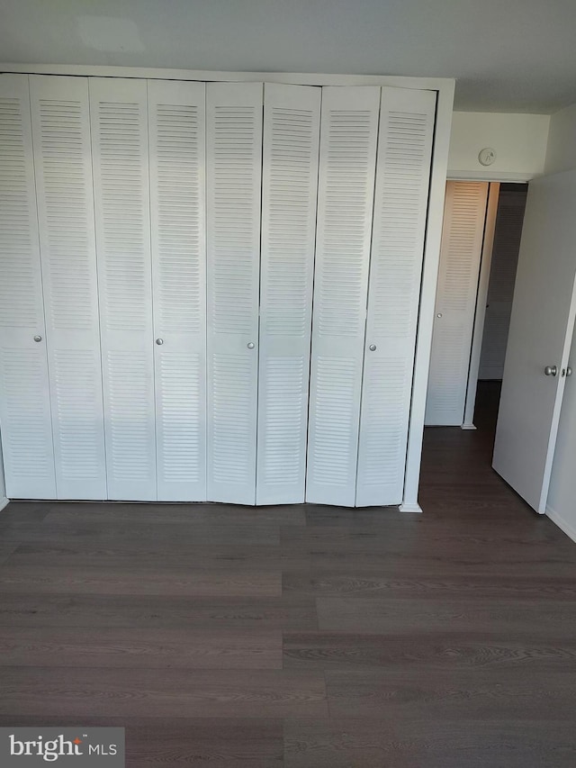 1301 Delaware Ave SW Unit N103, Washington, DC 20024 - unfurnished bedroom featuring dark wood-type flooring and a closet