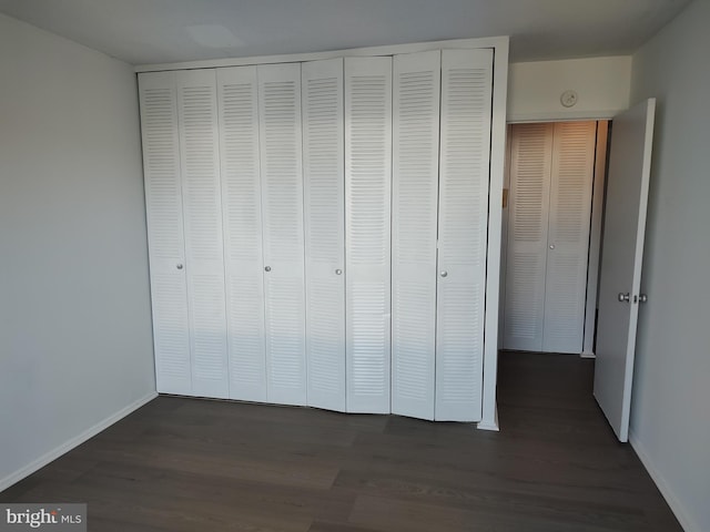 1301 Delaware Ave SW Unit N103, Washington, DC 20024 - unfurnished bedroom featuring dark wood-type flooring and a closet