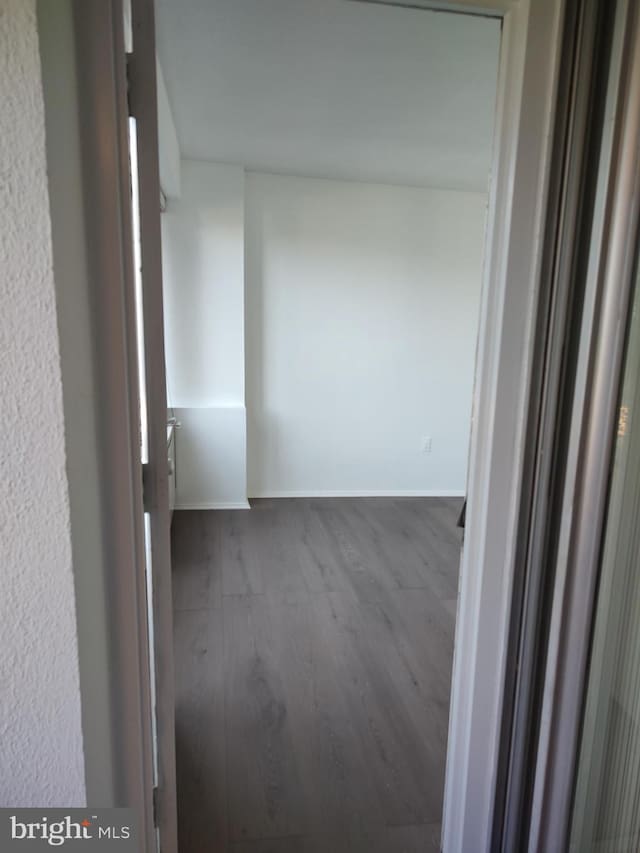1301 Delaware Ave SW Unit N103, Washington, DC 20024 - hallway with dark wood-style flooring and baseboards