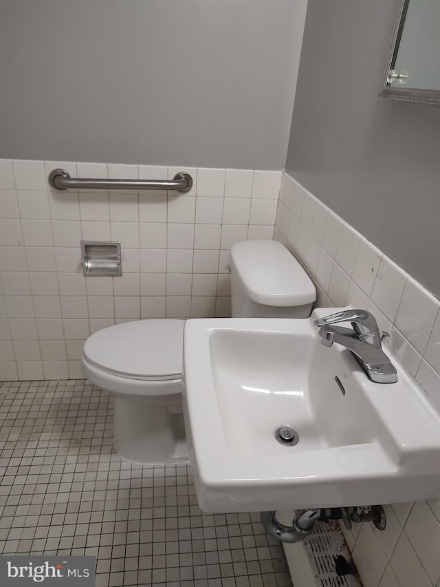 1301 Delaware Ave SW Unit N103, Washington, DC 20024 - half bath with tile walls, tile patterned flooring, and a wainscoted wall