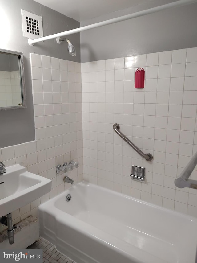 1301 Delaware Ave SW Unit N103, Washington, DC 20024 - bathroom featuring tile walls and washtub / shower combination