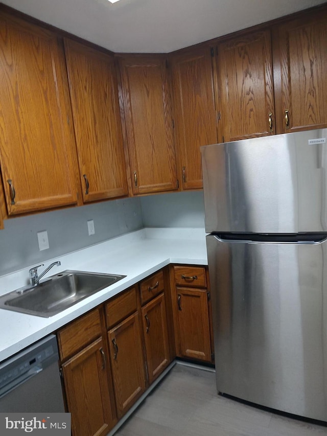 1301 Delaware Ave SW Unit N103, Washington, DC 20024 - kitchen featuring appliances with stainless steel finishes, brown cabinetry, and light countertops