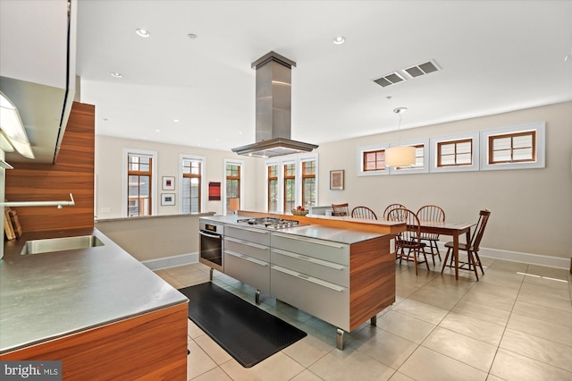 9 E Walnut St, Alexandria, VA 22301 - kitchen with island range hood, light tile patterned flooring, modern cabinets, appliances with stainless steel finishes, and recessed lighting