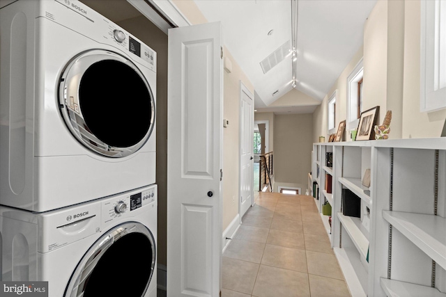 9 E Walnut St, Alexandria, VA 22301 - washroom with stacked washer / dryer and light tile patterned flooring