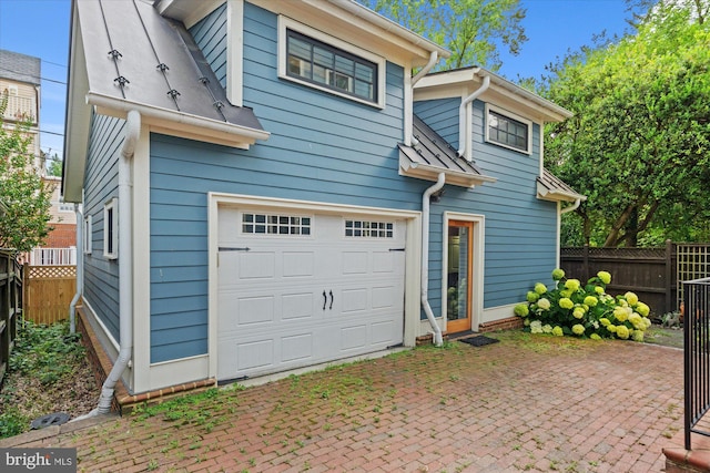 9 E Walnut St, Alexandria, VA 22301 - back of house with an attached garage and a patio area