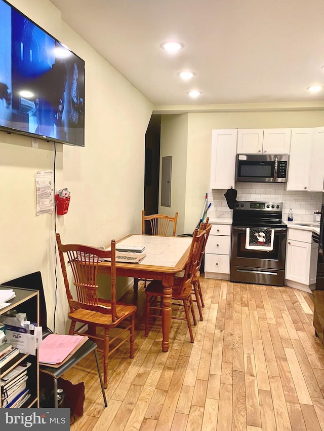 2538 N 16th St, Philadelphia, PA 19132 - dining room featuring light wood-type flooring, recessed lighting, and electric panel
