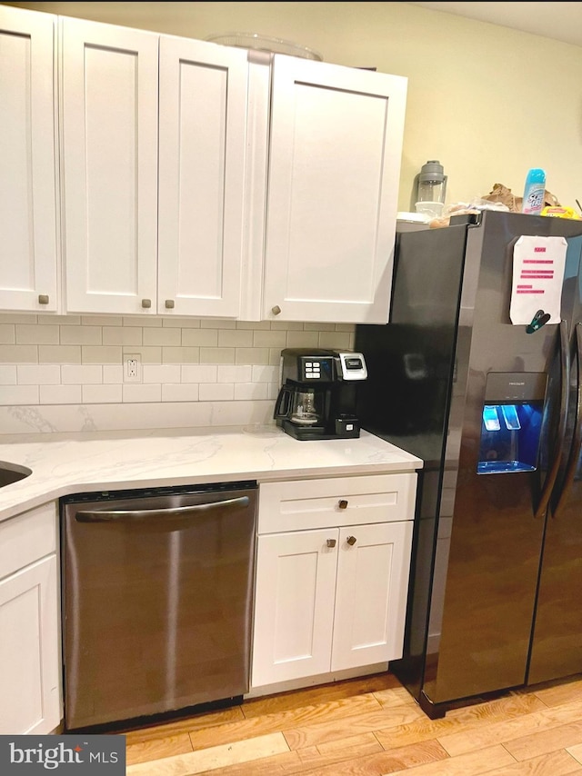 2538 N 16th St, Philadelphia, PA 19132 - kitchen with stainless steel appliances, white cabinets, light wood finished floors, and light stone counters