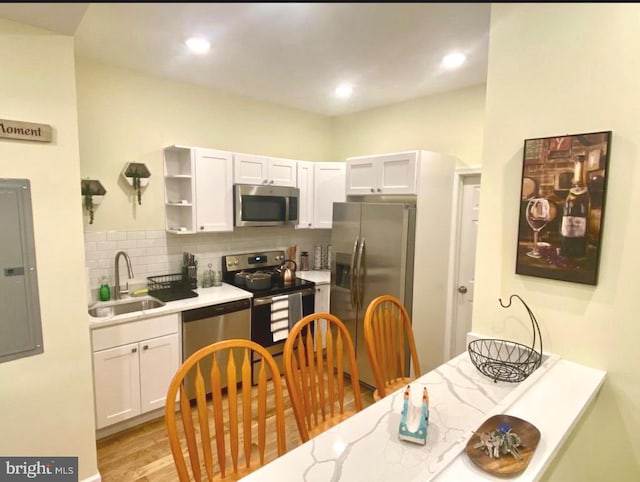 2538 N 16th St, Philadelphia, PA 19132 - kitchen featuring appliances with stainless steel finishes, light countertops, backsplash, white cabinetry, and recessed lighting