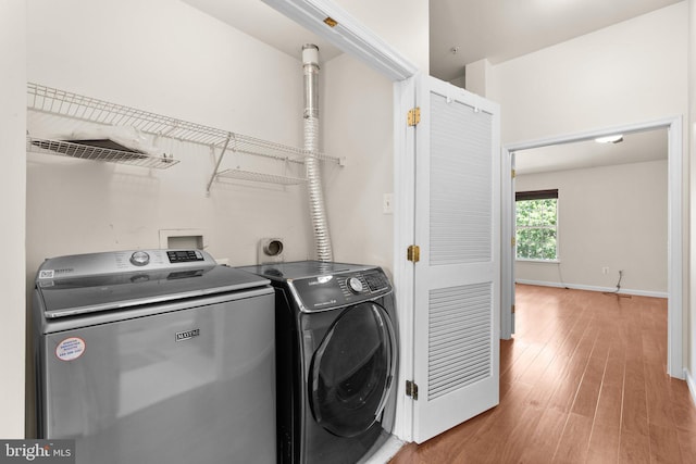 9956 Fragrant Lilies Way, Laurel, MD 20723 - laundry area with washing machine and dryer and light wood finished floors