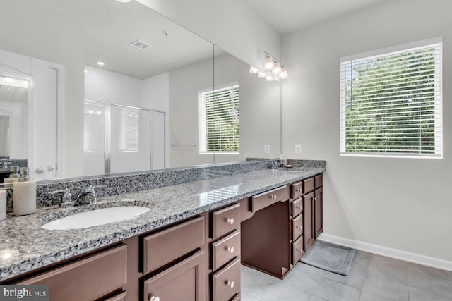 8321 Meadowood Dr, Hanover, MD 21076 - full bathroom with double vanity, healthy amount of natural light, a stall shower, and tile patterned flooring