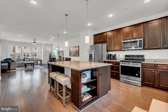 8321 Meadowood Dr, Hanover, MD 21076 - kitchen featuring appliances with stainless steel finishes, dark brown cabinetry, wood finished floors, open shelves, and recessed lighting