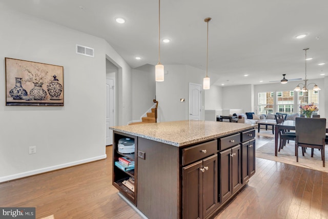8321 Meadowood Dr, Hanover, MD 21076 - kitchen with wood finished floors, dark brown cabinets, a ceiling fan, decorative light fixtures, and recessed lighting