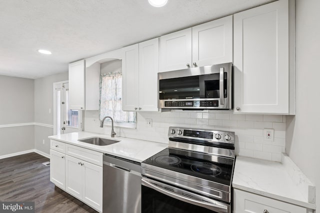 9228 Pinenut Ct, Laurel, MD 20723 - kitchen with appliances with stainless steel finishes, white cabinets, backsplash, and recessed lighting