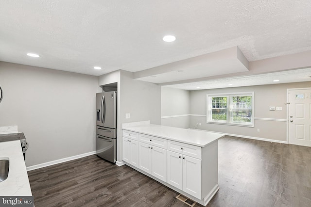 9228 Pinenut Ct, Laurel, MD 20723 - kitchen with stainless steel fridge with ice dispenser, a peninsula, dark wood-style flooring, light countertops, and white cabinetry