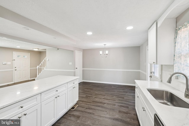 9228 Pinenut Ct, Laurel, MD 20723 - kitchen featuring white cabinetry, recessed lighting, dark wood-style flooring, a chandelier, and a textured ceiling