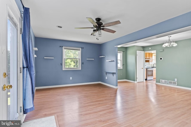 1142 Pheasant Dr N, Carlisle, PA 17013 - unfurnished living room featuring ceiling fan, healthy amount of natural light, light wood-type flooring, and a chandelier