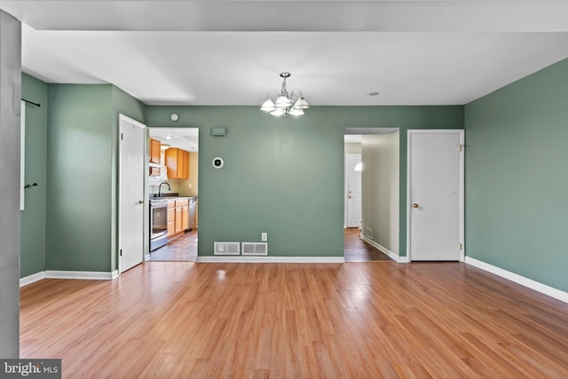 1142 Pheasant Dr N, Carlisle, PA 17013 - unfurnished room with a chandelier and light wood-type flooring