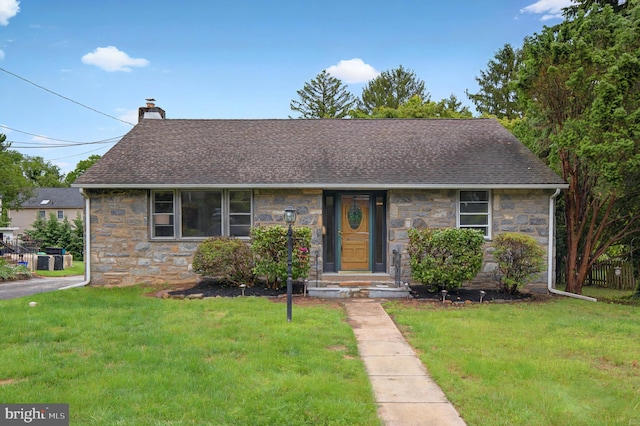 3 Arbor Lea Rd, Lansdowne, PA 19050 - view of front of home featuring stone siding, a chimney, roof with shingles, and a front lawn