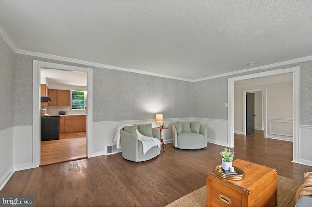 3 Arbor Lea Rd, Lansdowne, PA 19050 - living area featuring wood finished floors, crown molding, a wainscoted wall, and a textured ceiling