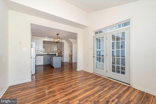 1724 Derrs Sq E, Frederick, MD 21701 - unfurnished living room with a chandelier and dark wood-style floors