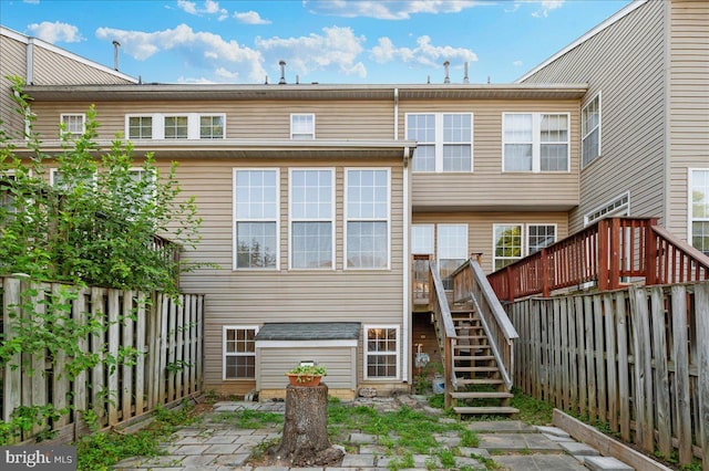 1724 Derrs Sq E, Frederick, MD 21701 - back of property with stairs, a fenced backyard, and a deck