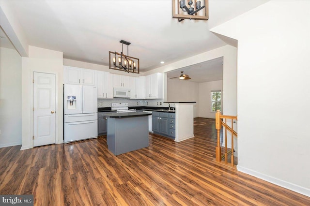 1724 Derrs Sq E, Frederick, MD 21701 - kitchen with white appliances, dark countertops, a chandelier, white cabinets, and a kitchen island