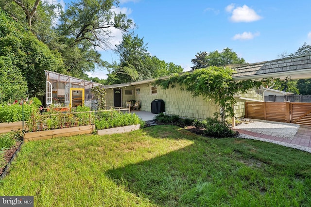 2307 Sherwood Hall Ln, Alexandria, VA 22306 - view of yard with a garden, a greenhouse, and a patio