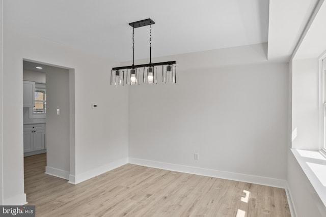 4 New Coach Ln, Willingboro, NJ 08046 - unfurnished dining area with light wood-type flooring and a chandelier